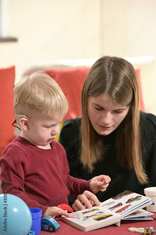 Fototapeta premium A Boy With A Hearing Aids And Cochlear Implants