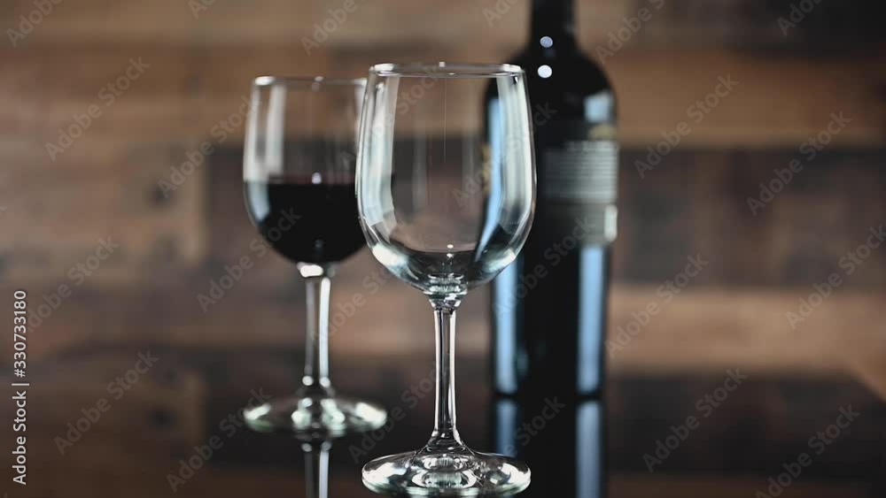 low motion closeup pouring a glass of red wine low motion closeup pouring a glass of red wine
