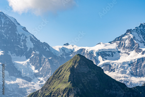 Switzerland, Panoramic view on Eiger, Monch and Jungfraujoch and green Alps around Mannlichen