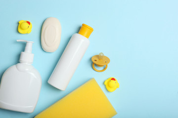 Baby care products on a colored background top view. Daily baby care products for skin care, for bathing. Hygiene of the newborn.
