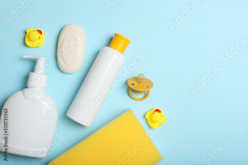 Baby care products on a colored background top view. Daily baby care products for skin care, for bathing. Hygiene of the newborn.