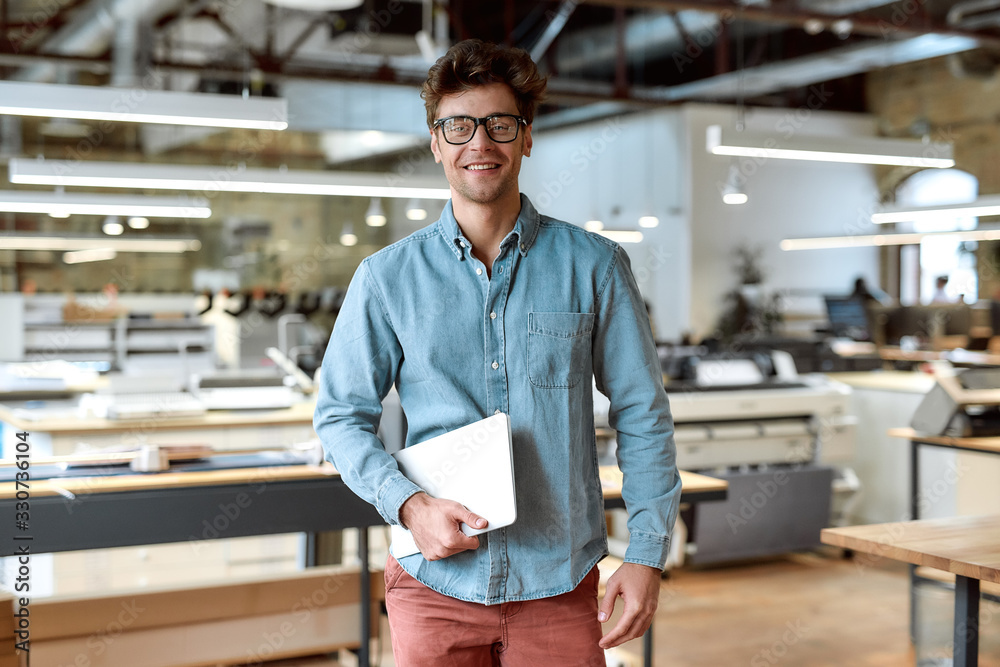 Keep calm and work hard. Young businessman posing in office