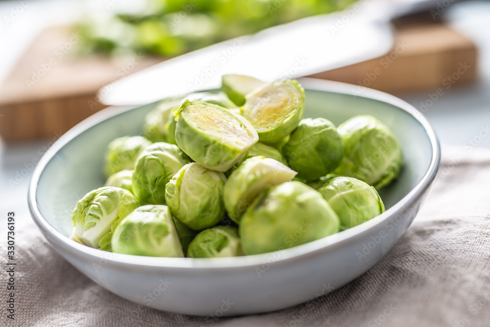 Fresh brusseles sprouts in bowl on kitchen table Fresh brusseles sprouts in bowl on kitchen table