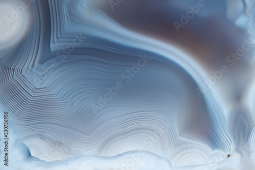 Close- up texture of blue -white agate with a smooth concentric structure