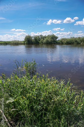 Beautiful spring river in the flowing nature. Colorful landscape in the morning and evening. Travel to deserted places of the world. Stock photo for design