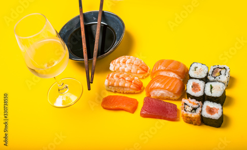 Varias porciones de Sushi con salsa de soja y vino blanco