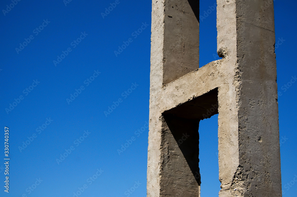 old concrete structure against a bright blue sky