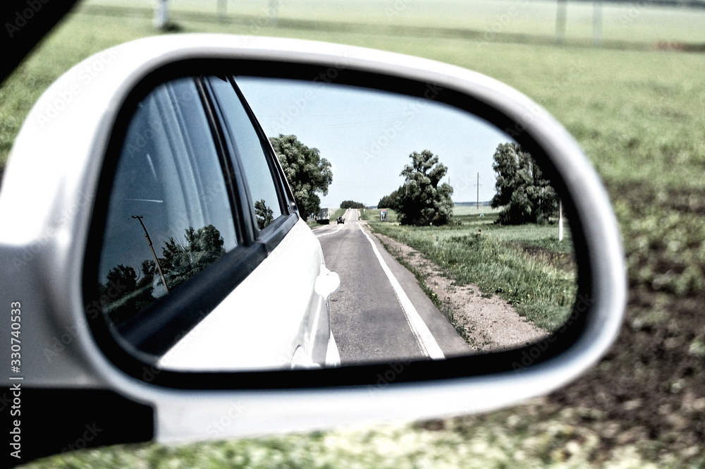 summer road in the reflection of the rear view mirror summer road in the reflection of the rear view mirror
