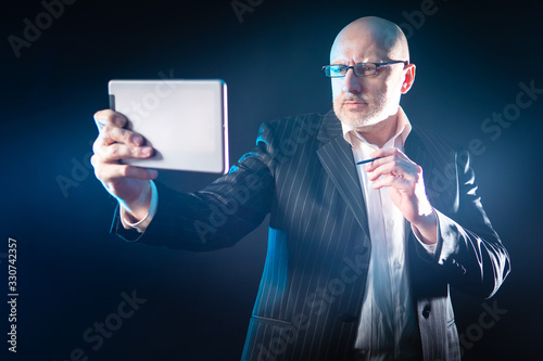 A man with an electronic ta...