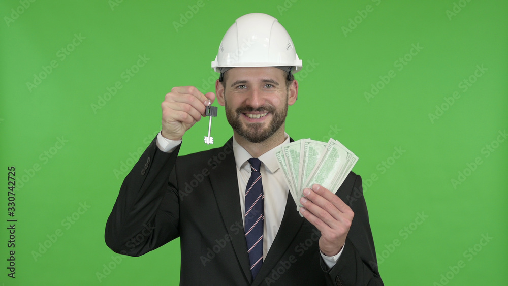 The Cheerful Engineer with House key and Money against Chroma Key The Cheerful Engineer with House key and Money against Chroma Key