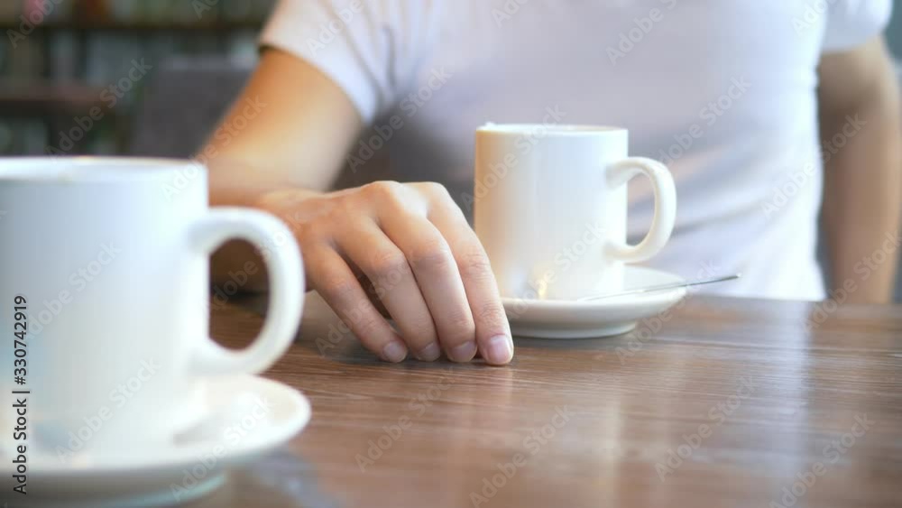 closeup. the man wears a wedding ring, sitting in a cafe. closeup. the man wears a wedding ring, sitting in a cafe.