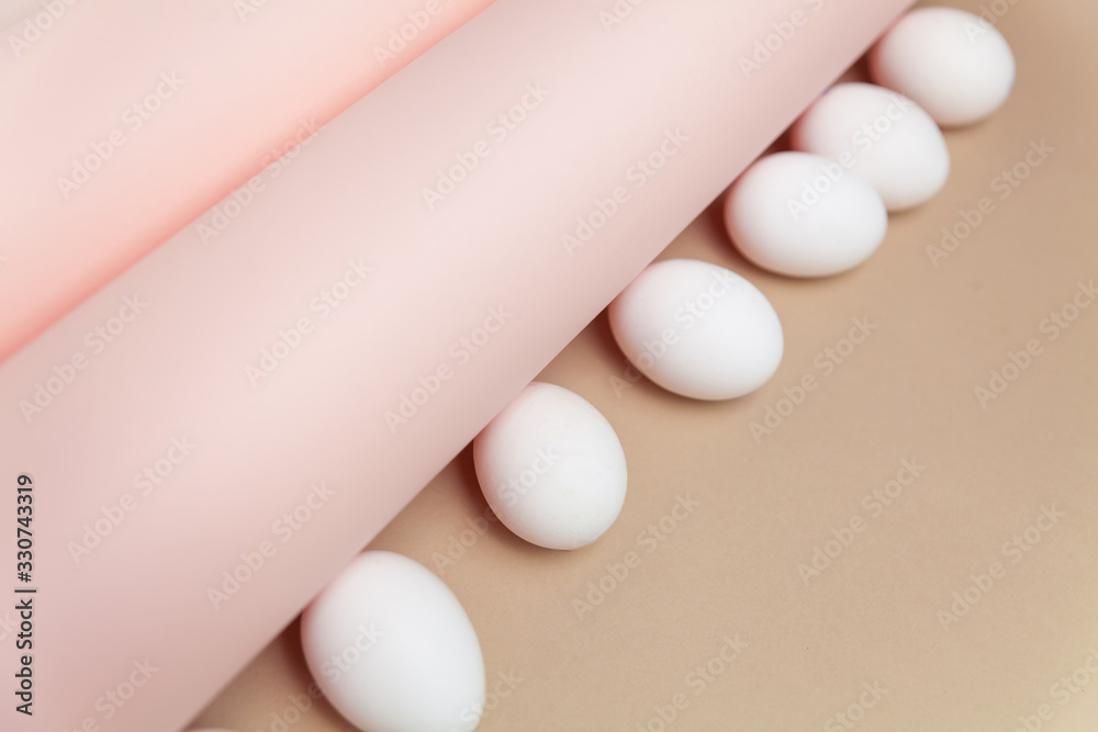 Creative Easter beige and pink background with white eggs. Easter holiday minimal concept. Creative Easter beige and pink background with white eggs. Easter holiday minimal concept.