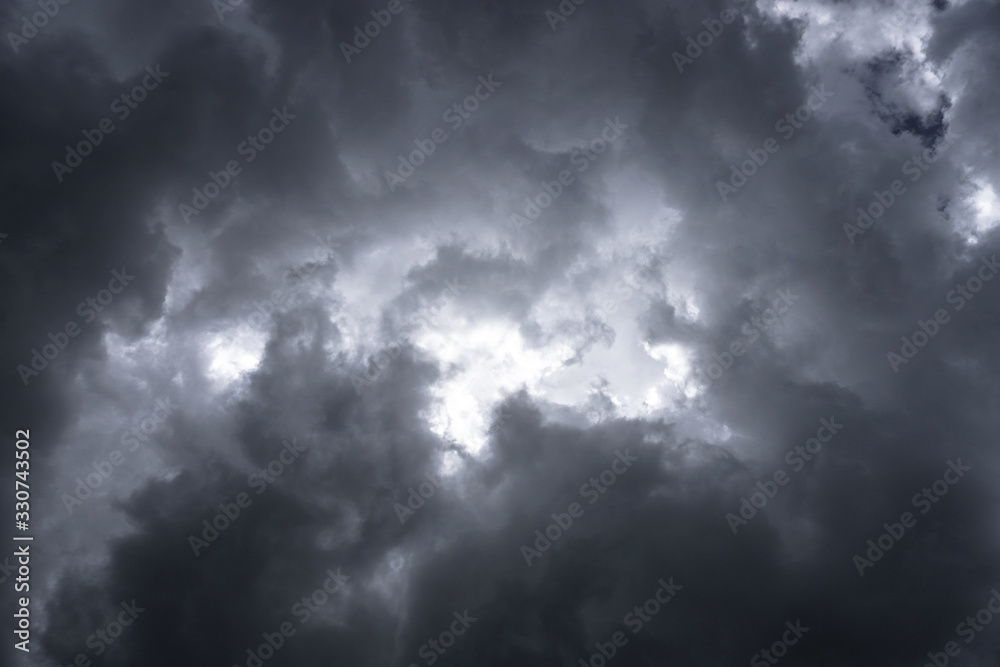 Terrible thunderclouds from the side of a plane. Gloomy epic clouds. Background image in a dark gray style. Terrible thunderclouds from the side of a plane. Gloomy epic clouds. Background image in a dark gray style.