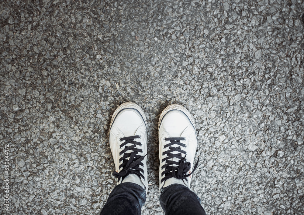 Personal feet selfie with sneakers of traveler standing on street. Travel and wanderlust tourism concept. Personal feet selfie with sneakers of traveler standing on street. Travel and wanderlust tourism concept.
