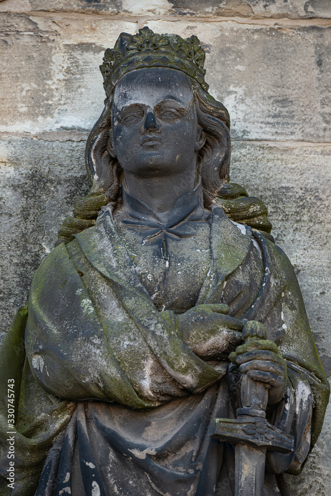 Ancient statue portrait of a princess knight as gatekeeper in Magdeburg Cathedral as Magdeburg, Germany, closeup, details
