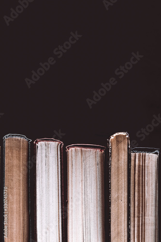 Pile of old books on a black background