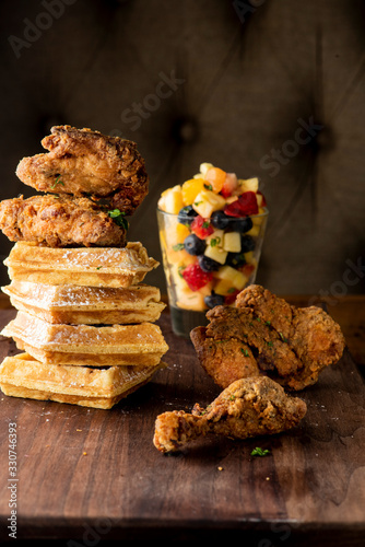 Chicken & waffles. Classic American Diner Style Breakfast or Brunch menu item favorite. Crispy homemade fried chicken on top of home buttermilk waffles topped with butter and maple syrup. 