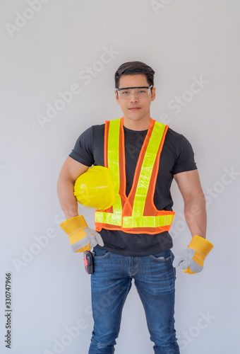 The foreman stands with a yellow safety helmet and wears gloves on a white background.