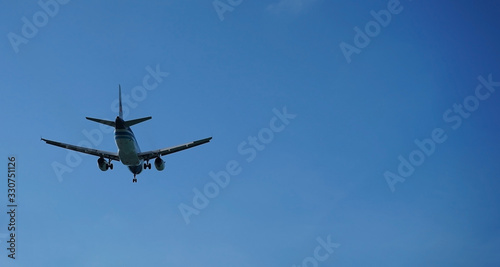 The plane flying in the blue sky. with the clear wiev of the jet.