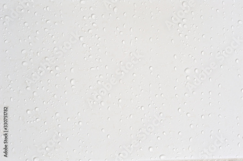 Beautiful water drops at a clean wall in difference sizes from small ones to big ones nice and perfect background for many occasions