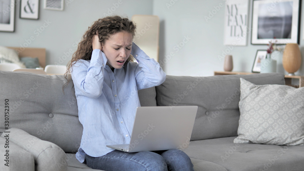 Frustrated Curly Hair Woman Reacting to Loss on Laptop while Sitting on Couch Frustrated Curly Hair Woman Reacting to Loss on Laptop while Sitting on Couch