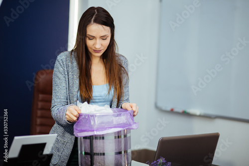 frustrated businesswoman via Coronavirus.A stressed tired businesswoman feeling exhausted sitting at office desk with laptop