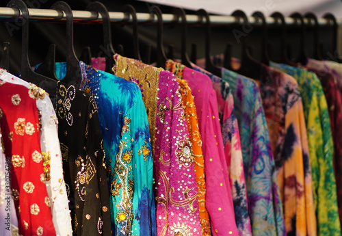  Closeup view of Indian woman fancy and fashion dress Hung on hangers in display of a retail shop 