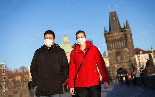 Couple walking with the veils the historical centrum in Prague, Czech Republic, Europe during pandemic of coronavirus.