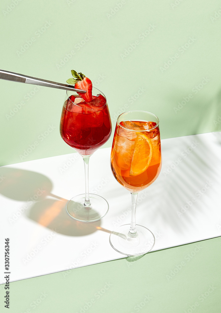 Red and orange summer cocktail on creative background