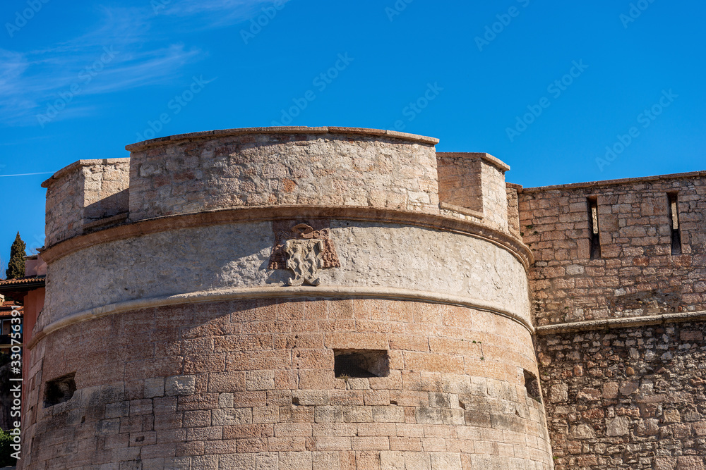 Castello del Buonconsiglio or Castelvecchio, Medieval castle in Trento city. Closeup of the fortified wall with the arrowslits or loopholes and a tower. Trentino Alto Adige, Italy, Europe
