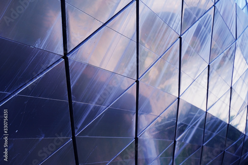 The mirror mosaic wall of skyskraper in different view with the sky and reflections.