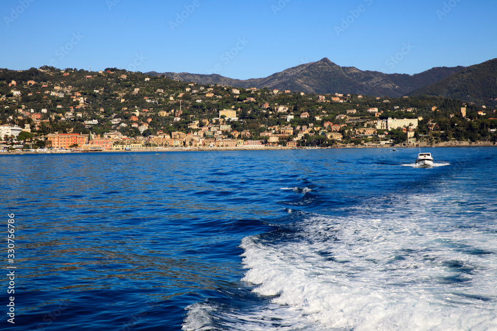 Obraz premium Santa Margherita Ligure (GE), Italy - June 01, 2017: Santa margherita Ligure village view from the boat sailing to Portofino, Genova, Liguria, Italy