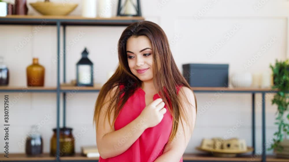 Beautiful girl sitting in living room and flirting with camera Beautiful girl sitting in living room and flirting with camera