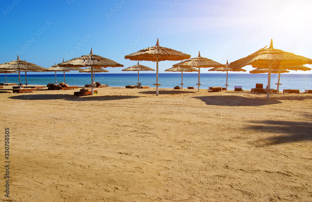 Tropical beach with umbrellas