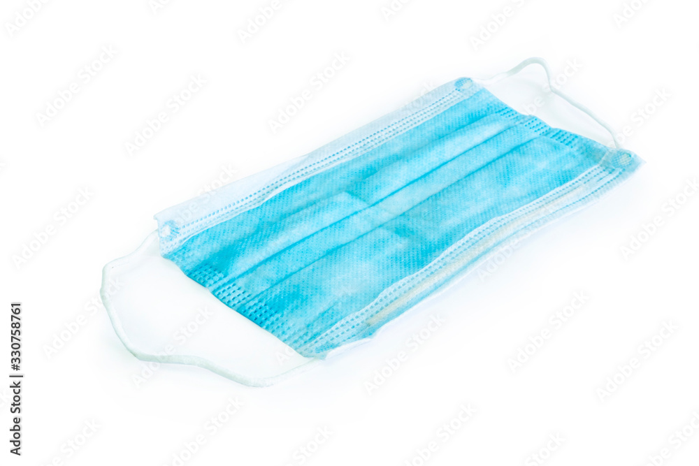 Fototapeta premium Blue medical surgical flu illness protective mask over isolated white background