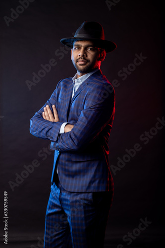 Indian young businessman on dark background © liliyabatyrova