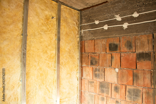 putting plasterboard on the wall preparation for insulation photo