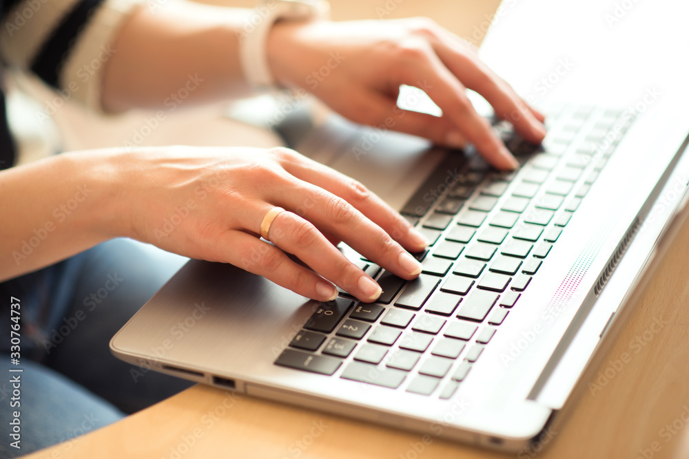 Woman hands typing on laptop computer keyboard at home, working from home, internet of things concept. Quarantine, isolation and work from home during pandemic epidemic coronavirus Woman hands typing on laptop computer keyboard at home, working from home, internet of things concept. Quarantine, isolation and work from home during pandemic epidemic coronavirus