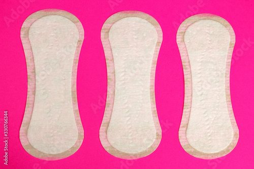 Women protection hygiene daily pads on pink background