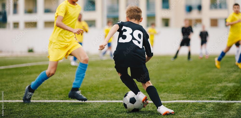 Obraz premium Kids Play Soccer Game. Children Outdoor Football Tournament Match on Grass Field