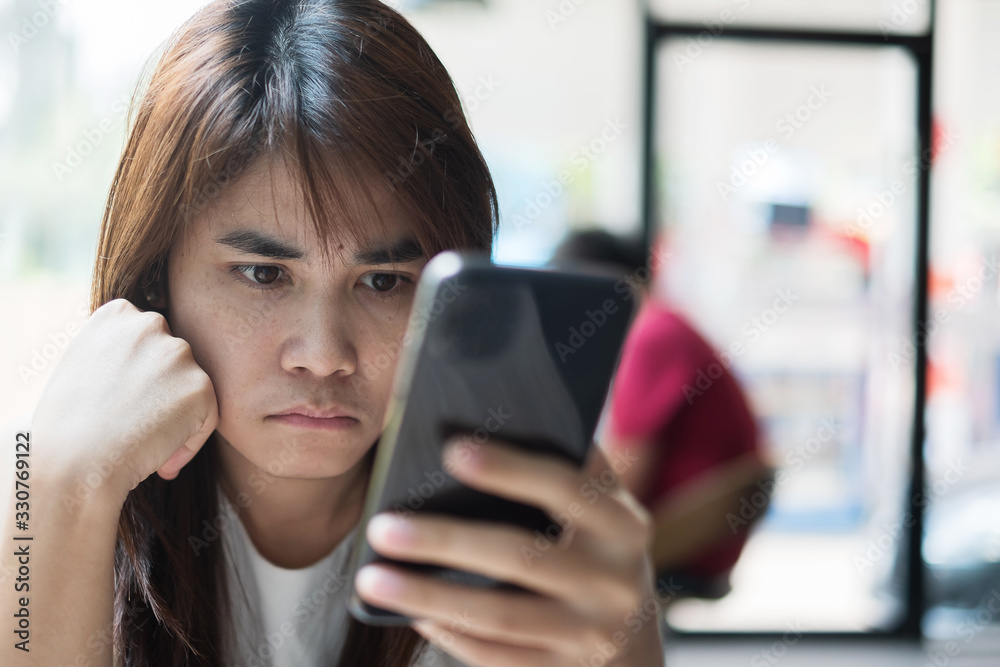 young asian Businesswoman feeling bored during using smartphone at office. Emotion, Technology and lifestyle concept young asian Businesswoman feeling bored during using smartphone at office. Emotion, Technology and lifestyle concept