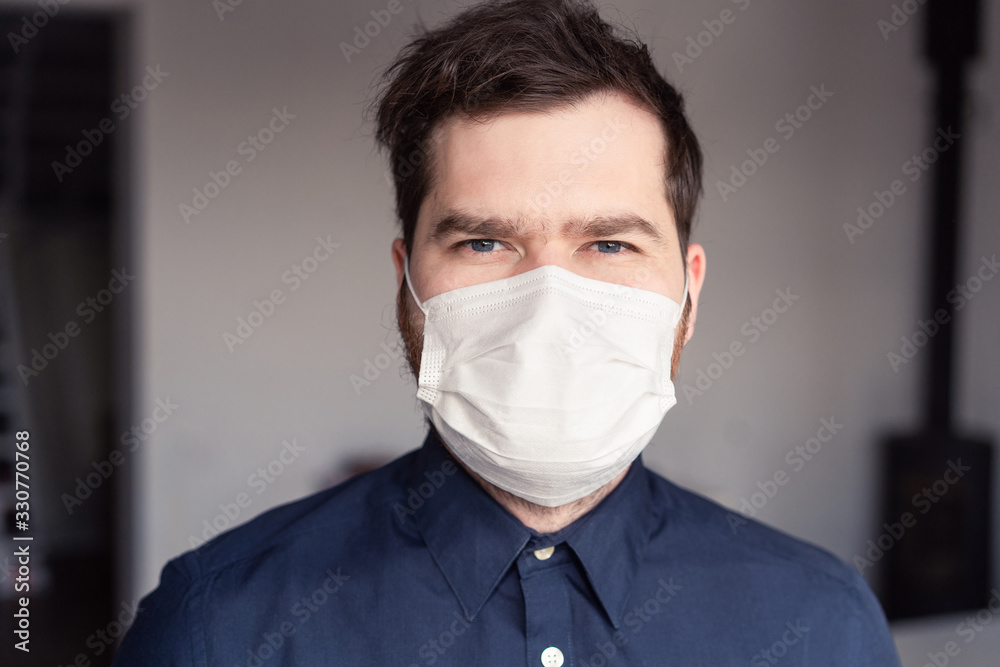 Men during epidemic in medical mask on light background