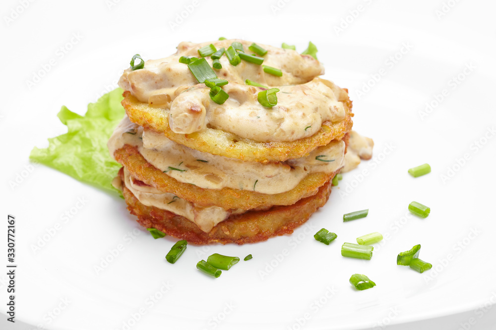potato pancakes with sauce and meat