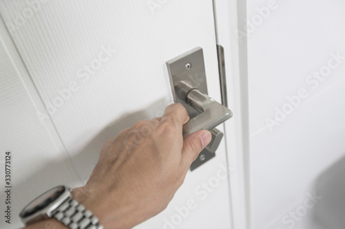 Hand is Holding Door Knob While Opening a Door