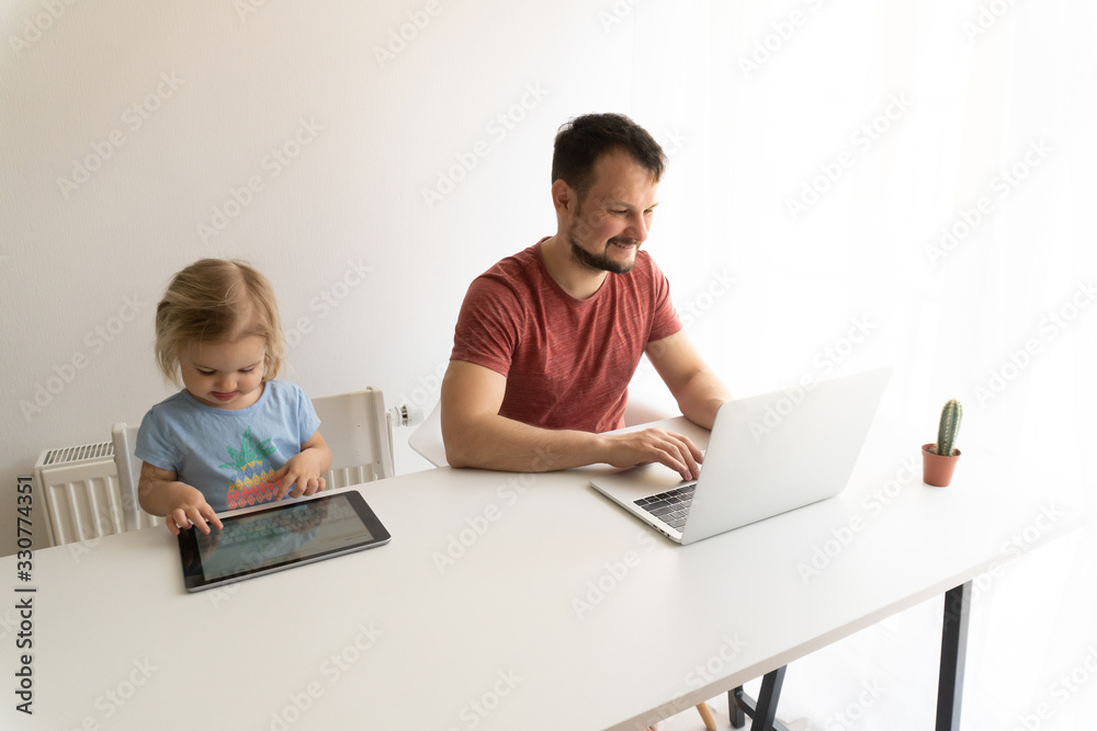 Child works from home like father at laptop. Quarantine time during coronavirus epidemia, everybody should stay at home. Home working and isolation concept. Time to be together. Child works from home like father at laptop. Quarantine time during coronavirus epidemia, everybody should stay at home. Home working and isolation concept. Time to be together.