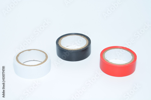 Photo of multicolored insulating tapes against the white background