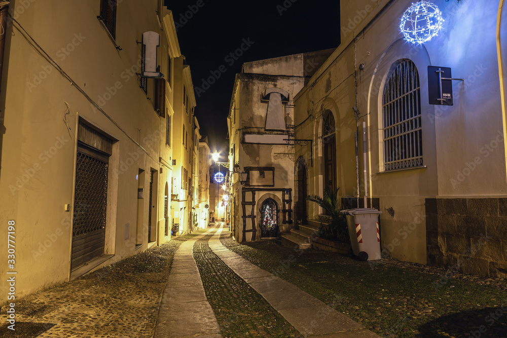 Picturesque street in old town Alghero by night