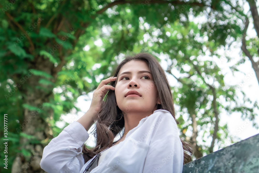 Beautiful Asian women with long hair wearing a white shirt. White bug hat, jeans showing emotions In the nature park-09.jpg, Asian beautiful woman with yellow skin, long black hair, wearing a white s Beautiful Asian women with long hair wearing a white shirt. White bug hat, jeans showing emotions In the nature park-09.jpg, Asian beautiful woman with yellow skin, long black hair, wearing a white s
