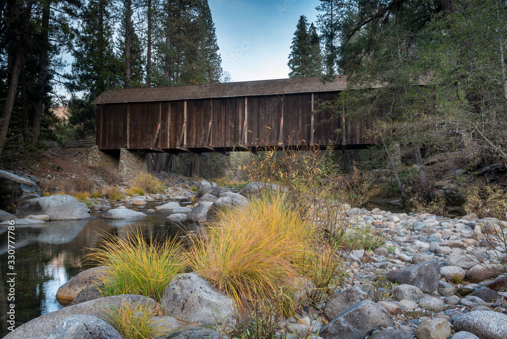 Εκτύπωση καμβά Yosemite Merced  River by Wawona‎, Mariposa, crossed by a covered wooden bridge