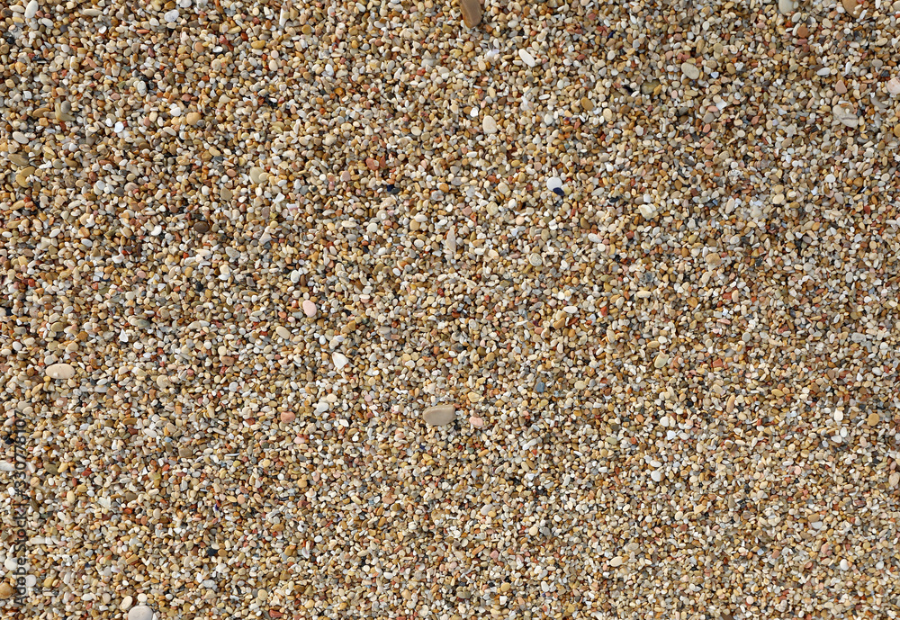 thousands of tiny pebbles smoothed by the waves of the sea thousands of tiny pebbles smoothed by the waves of the sea